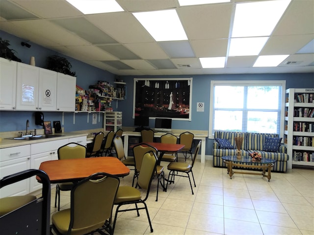 dining area with sink and a drop ceiling