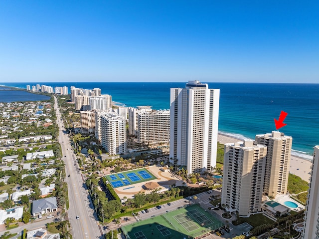 bird's eye view featuring a water view and a beach view