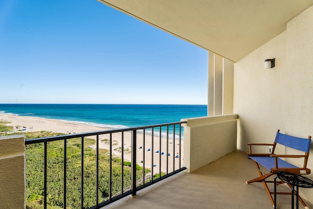 balcony with a view of the beach and a water view