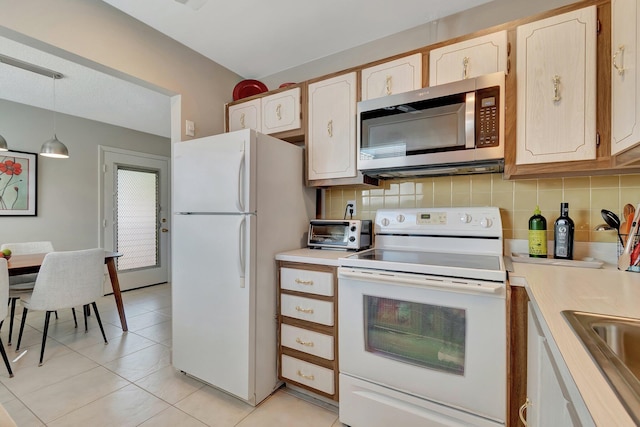 kitchen featuring pendant lighting, light brown cabinetry, tasteful backsplash, light tile patterned floors, and white appliances