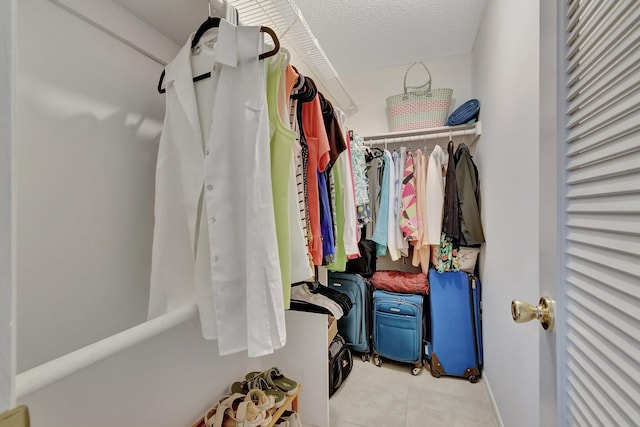 spacious closet featuring light tile patterned floors