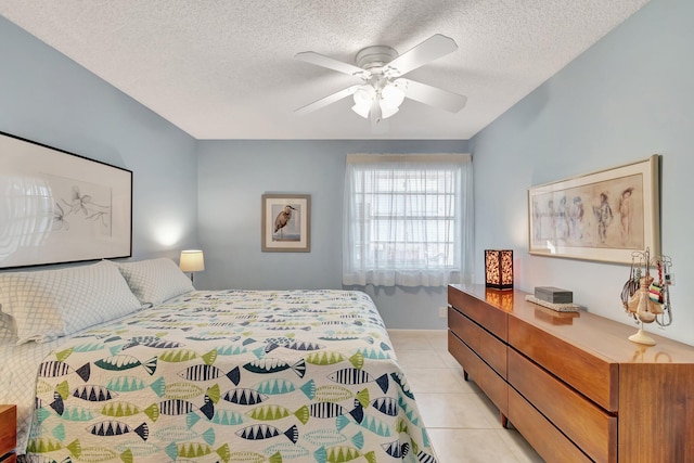 bedroom with light tile patterned floors, a textured ceiling, and ceiling fan