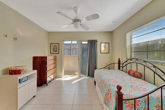 tiled bedroom featuring multiple windows, a textured ceiling, and ceiling fan