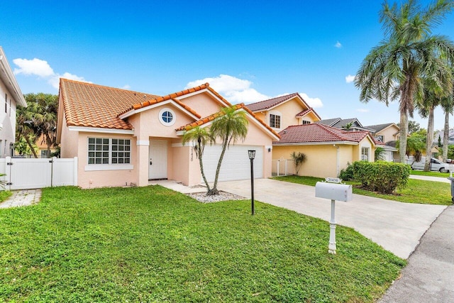 mediterranean / spanish house with a front yard and a garage