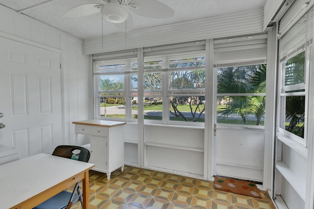 sunroom featuring ceiling fan