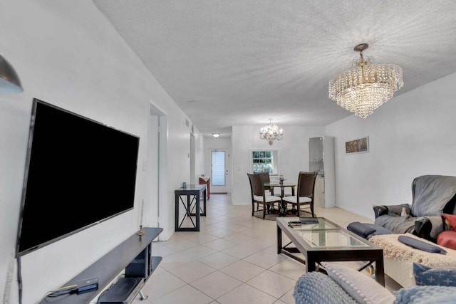 tiled living room featuring a textured ceiling and an inviting chandelier