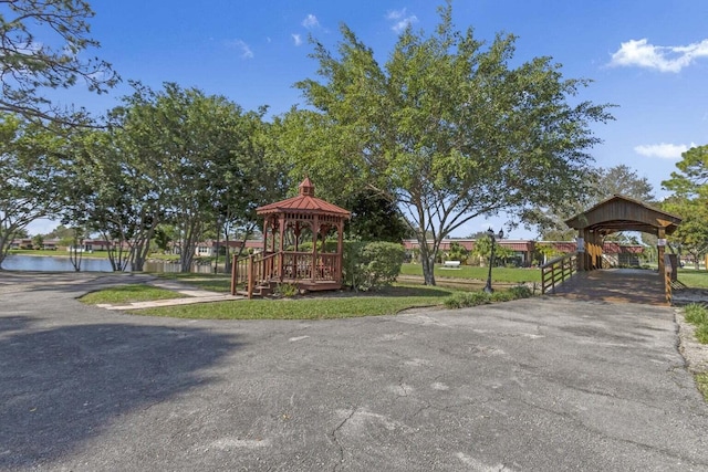 surrounding community with a gazebo and a water view