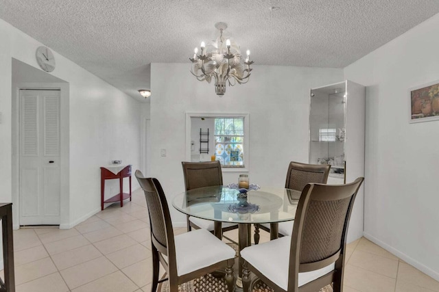 tiled dining room with a textured ceiling and a notable chandelier