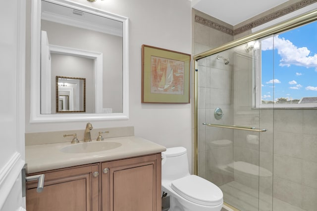 bathroom featuring toilet, vanity, crown molding, and walk in shower