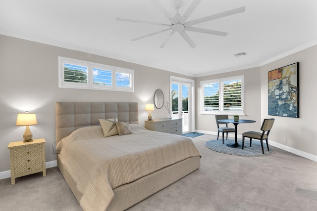 carpeted bedroom with ornamental molding and ceiling fan