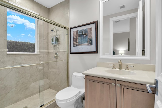 full bathroom with toilet, a stall shower, vanity, and visible vents