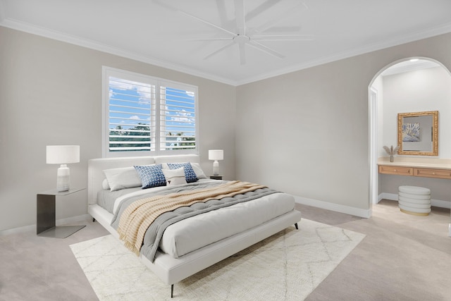 bedroom featuring crown molding, ceiling fan, and light carpet