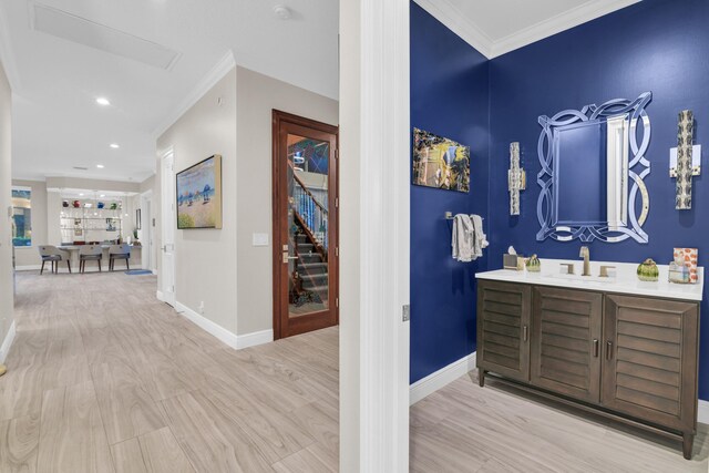 office area featuring a tray ceiling, light wood-type flooring, and baseboards