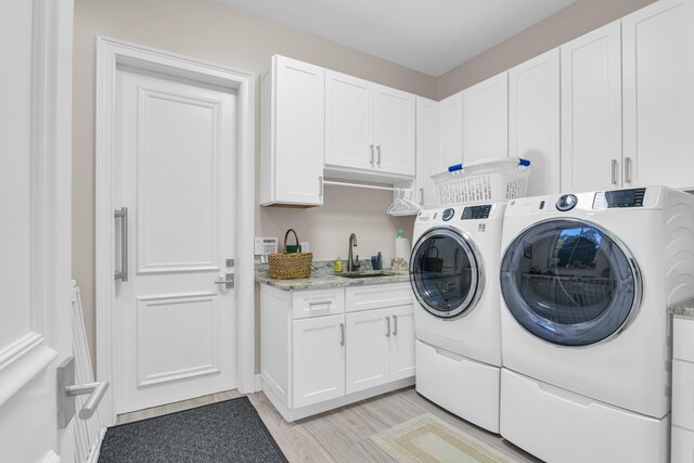 interior space with wood finished floors, ornamental molding, a sink, and baseboards