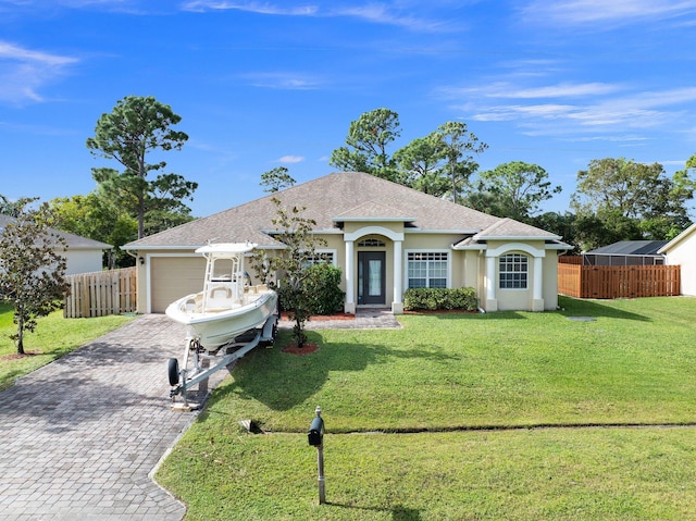 ranch-style home with a front lawn and a garage