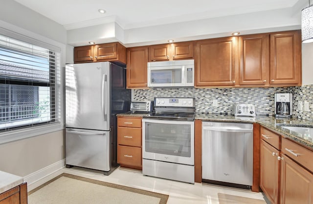 kitchen featuring stone counters, decorative backsplash, stainless steel appliances, and light tile patterned floors