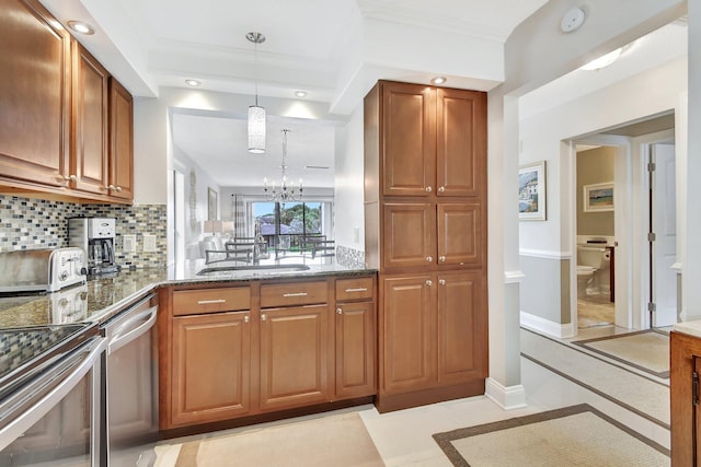 kitchen with sink, decorative light fixtures, dark stone countertops, dishwasher, and a chandelier