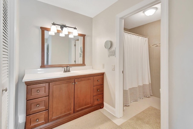 bathroom featuring a shower with shower curtain, vanity, and tile patterned flooring