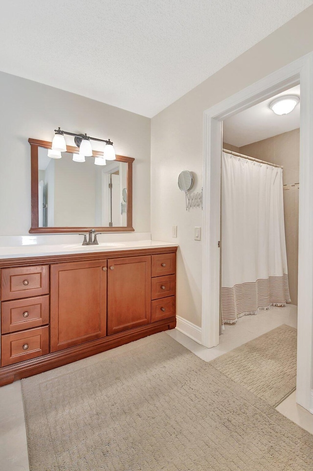 bathroom featuring vanity, a textured ceiling, and a shower with shower curtain