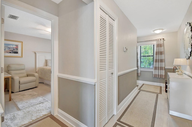 hallway with light tile patterned floors