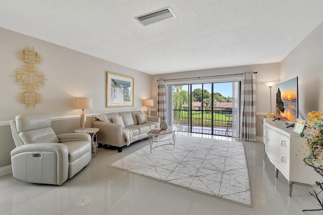 living room featuring light tile patterned floors and a textured ceiling