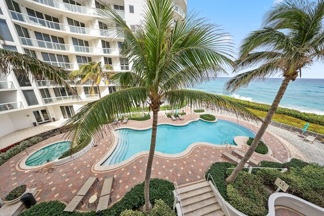 view of swimming pool featuring a water view