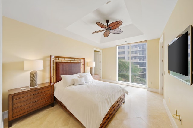 bedroom featuring a tray ceiling and ceiling fan