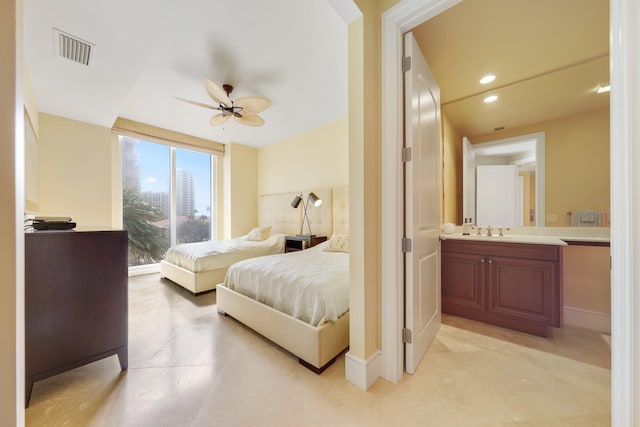 bedroom featuring ensuite bath, ceiling fan, and sink