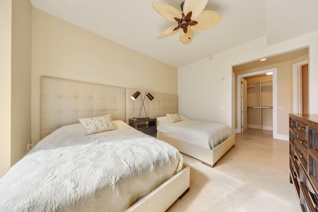 bedroom with ceiling fan, a closet, and a spacious closet