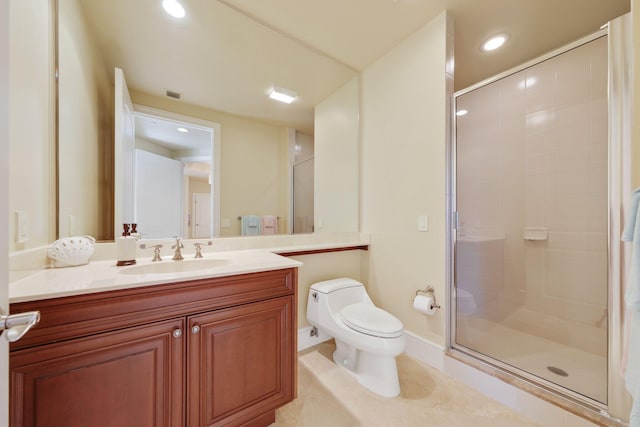 bathroom with tile patterned flooring, vanity, a shower with shower door, and toilet