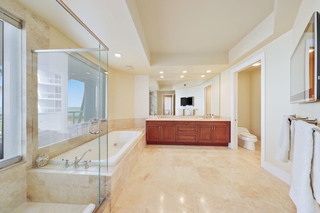 full bathroom featuring separate shower and tub, vanity, and toilet