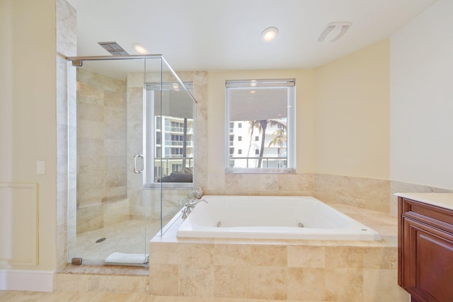 bathroom featuring plus walk in shower and vanity