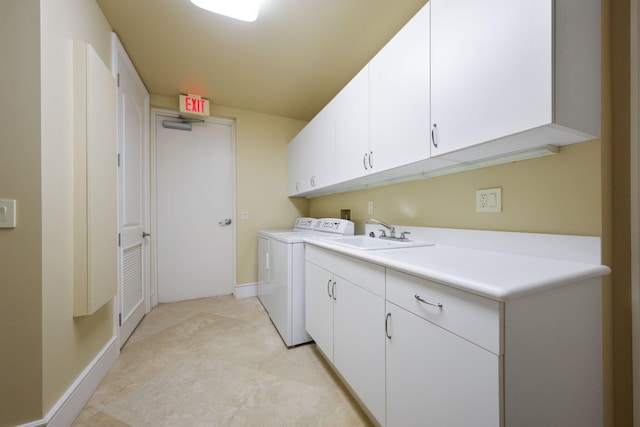 clothes washing area with cabinets, independent washer and dryer, and sink