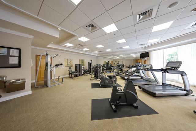 gym featuring a drop ceiling, carpet floors, and ornamental molding