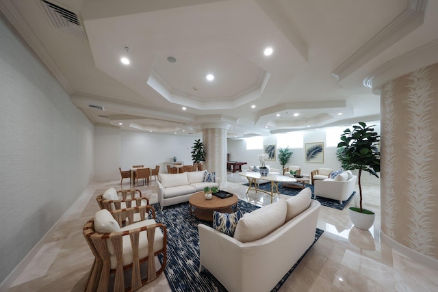 living room with a tray ceiling, decorative columns, and ornamental molding