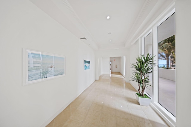 corridor featuring crown molding, light tile patterned floors, and a healthy amount of sunlight