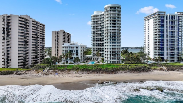 view of property featuring a beach view and a water view