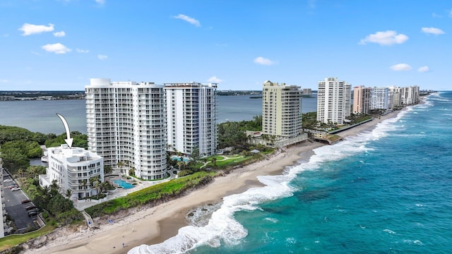 drone / aerial view with a water view and a beach view