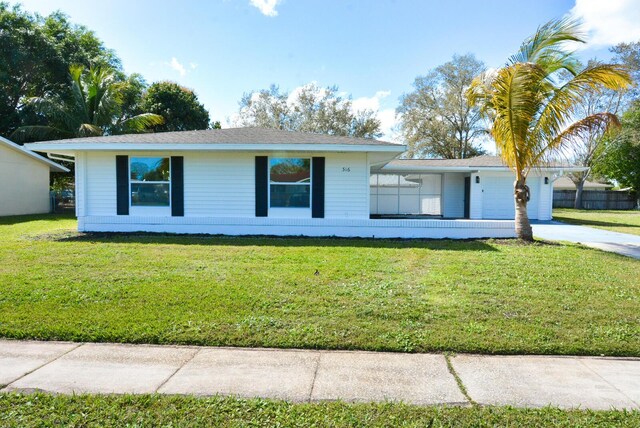 single story home featuring a garage and a front yard