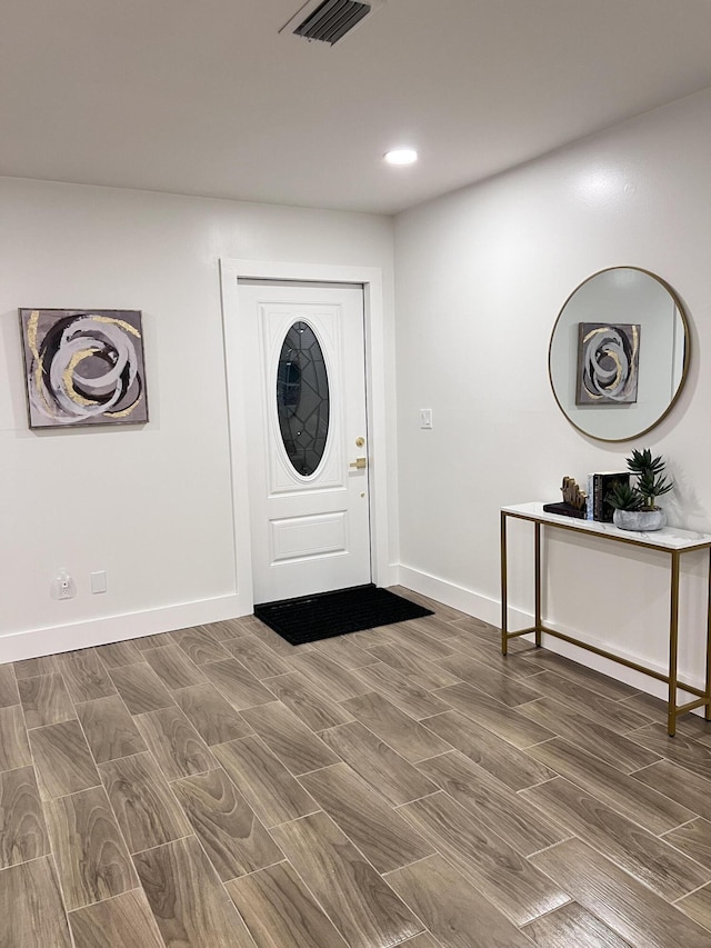 foyer entrance with recessed lighting, visible vents, and baseboards