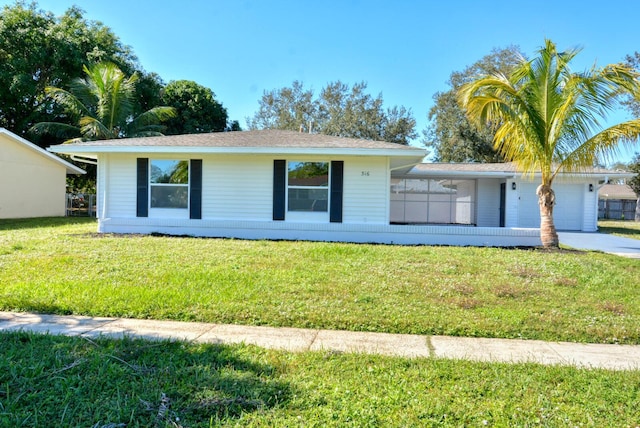 view of front of house with a front lawn, driveway, and an attached garage