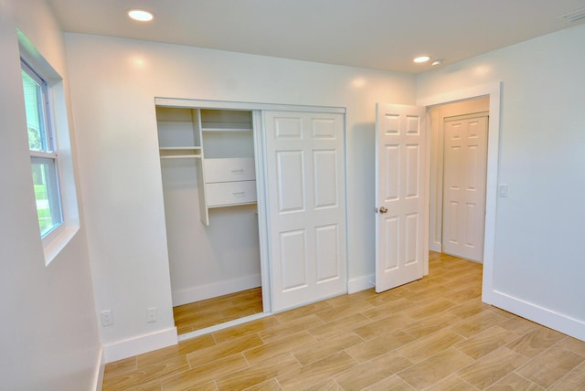 unfurnished bedroom with light wood finished floors, recessed lighting, visible vents, and baseboards