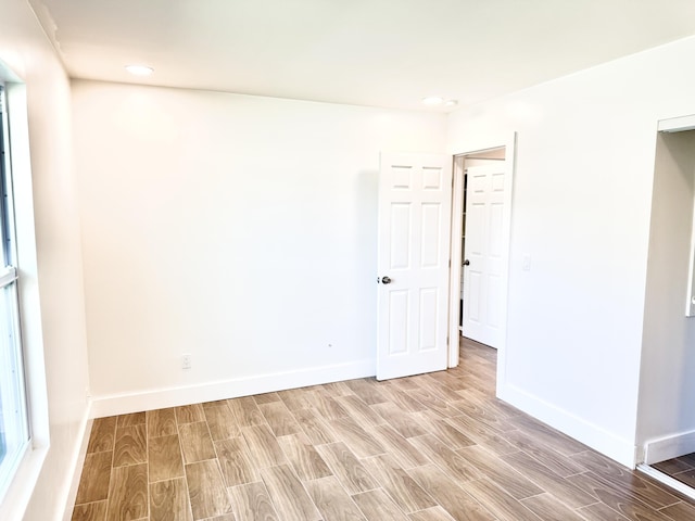 spare room with baseboards and wood tiled floor