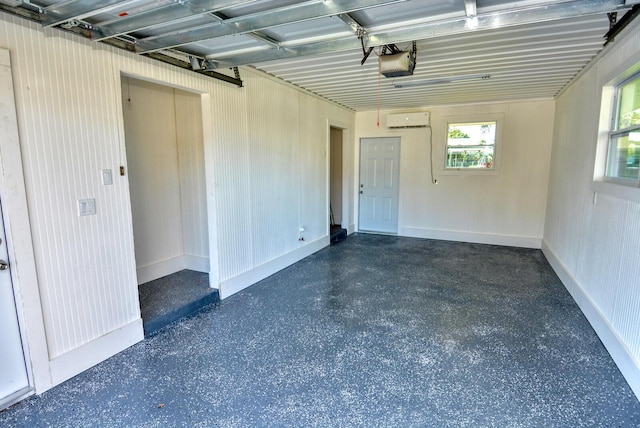 garage featuring a wall unit AC and a garage door opener