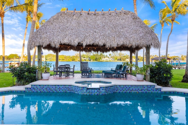 view of pool with a gazebo, a water view, an in ground hot tub, and a patio