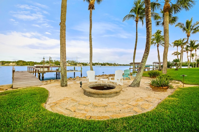 view of patio featuring a dock, a water view, and an outdoor fire pit