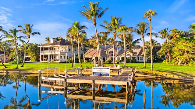 view of dock featuring a yard and a water view