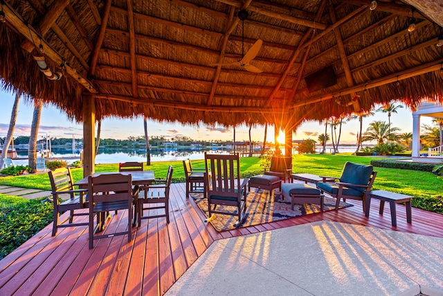 view of patio / terrace with a gazebo and a deck with water view