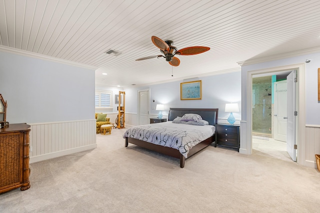 carpeted bedroom featuring ceiling fan, wooden ceiling, crown molding, and ensuite bath