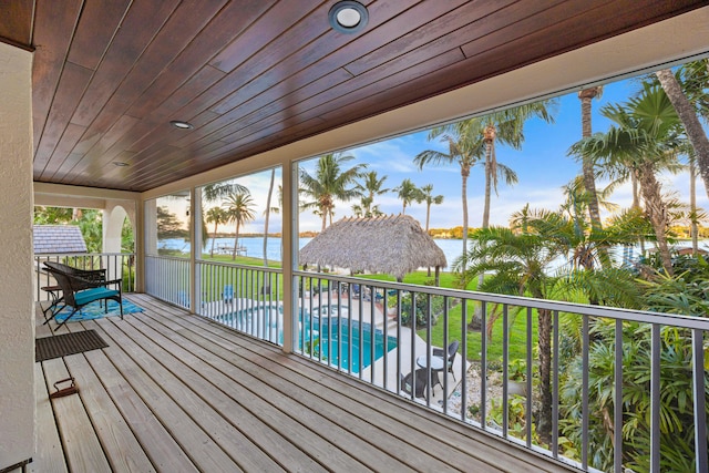 wooden terrace featuring a water view